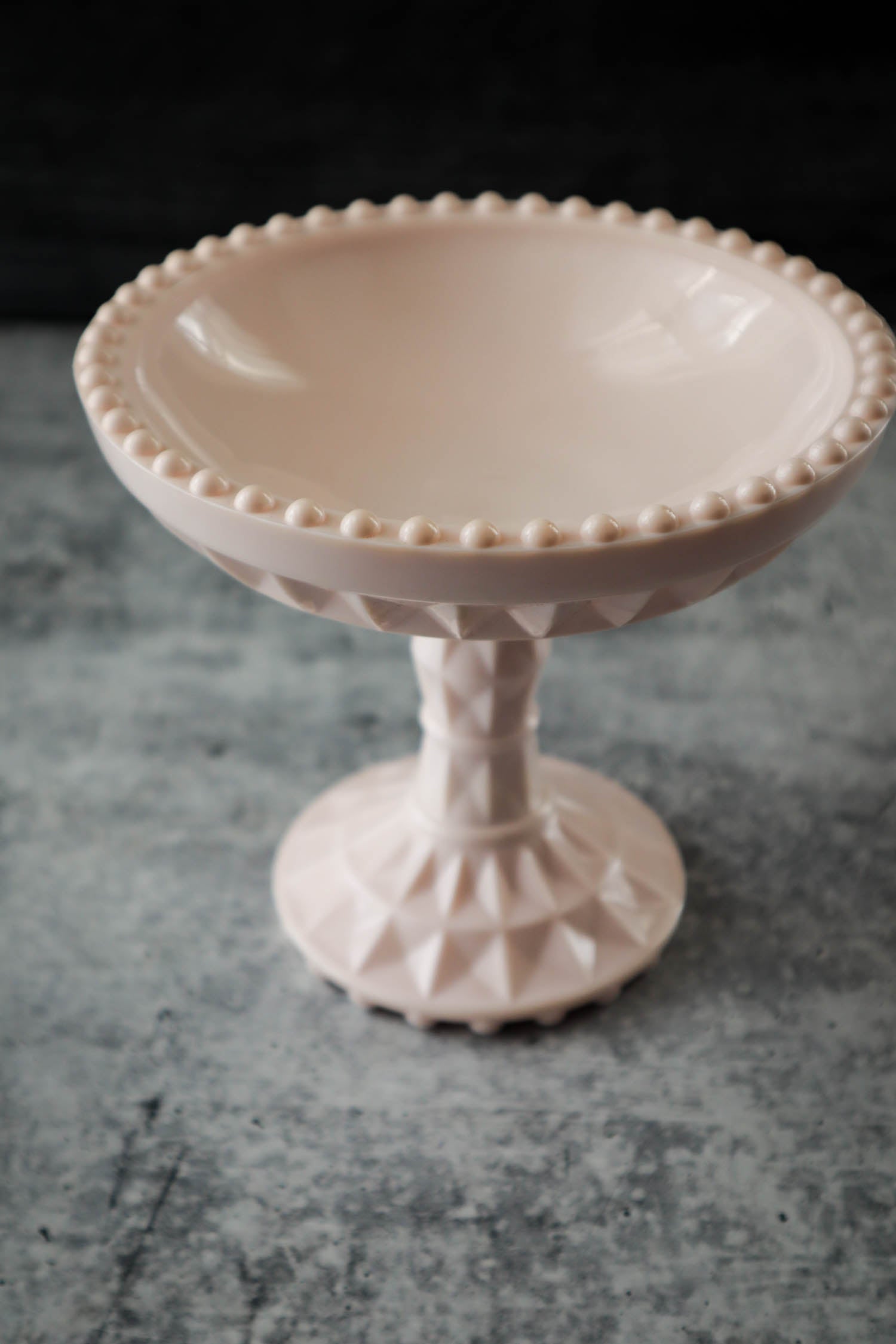 https://justdandies.co/cdn/shop/files/2366-jeanette-glass-pink-milk-glass-pedestal-bowl-compote-1.jpg?v=1689643515&width=1946